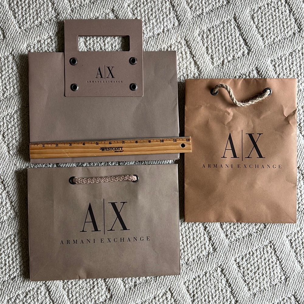 Three Armani Exchange paper bags